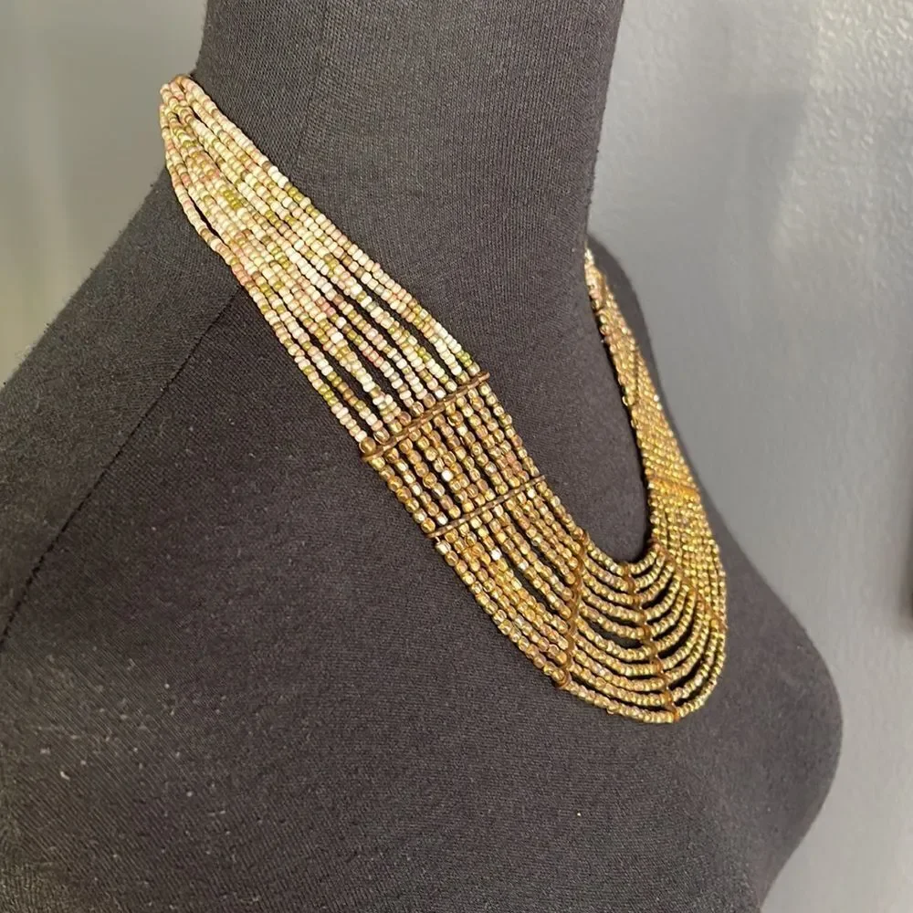 Multi strand bronze and pastel bead necklace.